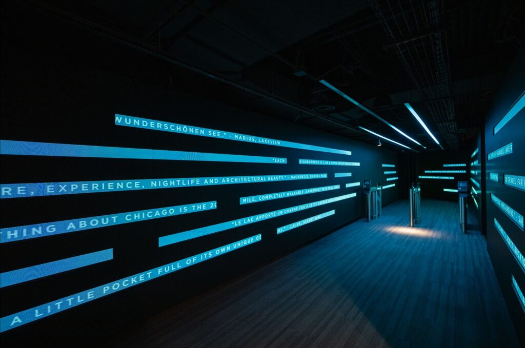 360 CHICAGO welcome experience, 875 North Michigan Avenue, Chicago — corridor of LED light strips with animated welcome typography