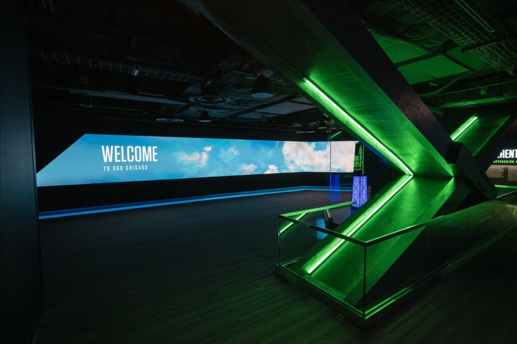 360 CHICAGO welcome experience, 875 North Michigan Avenue, Chicago — welcome hall with green LED chevron and panoramic screen