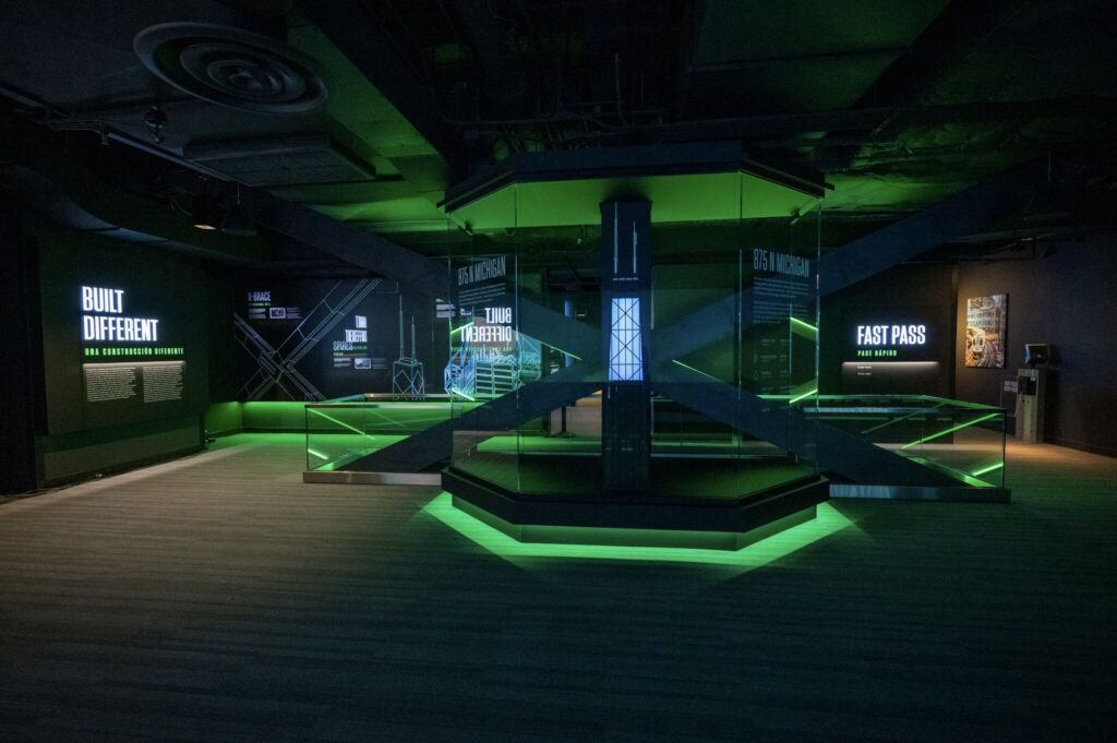 360 CHICAGO welcome experience, 875 North Michigan Avenue, Chicago — X-bracing model on an LED-lit platform