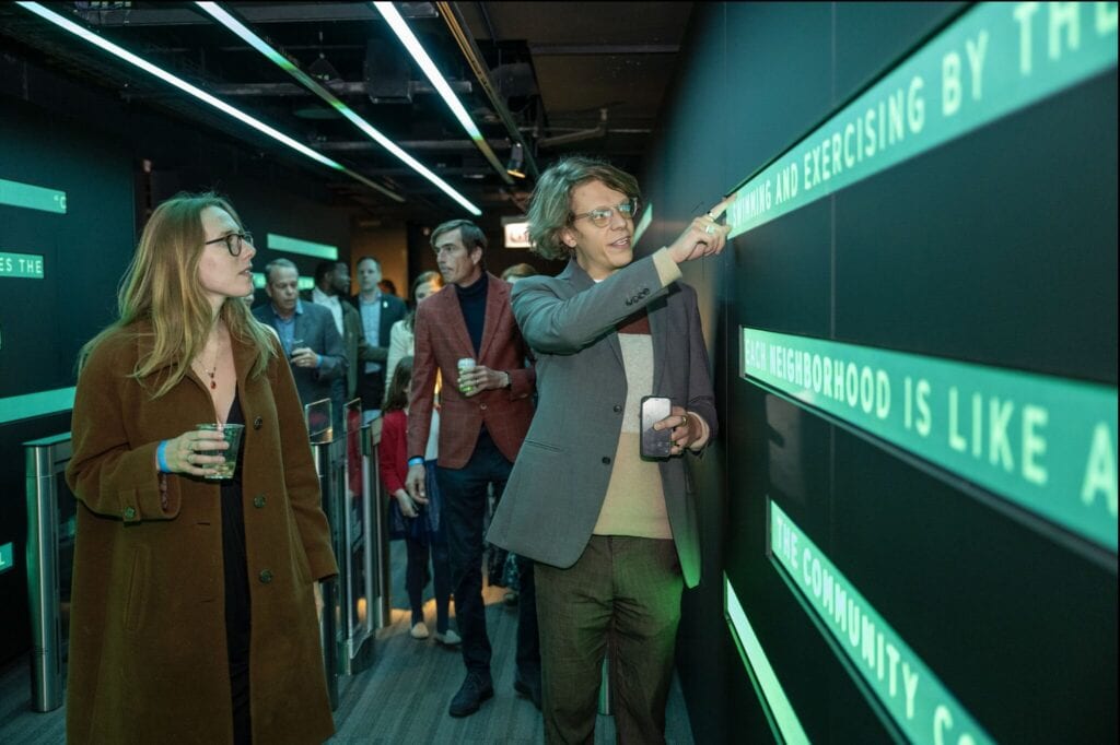 360 CHICAGO welcome experience, 875 North Michigan Avenue, Chicago — guests at the opening in the LED typography hallway