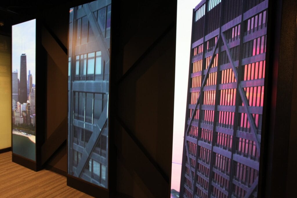 360 CHICAGO welcome experience, 875 North Michigan Avenue, Chicago — framed LED portal panels with building imagery