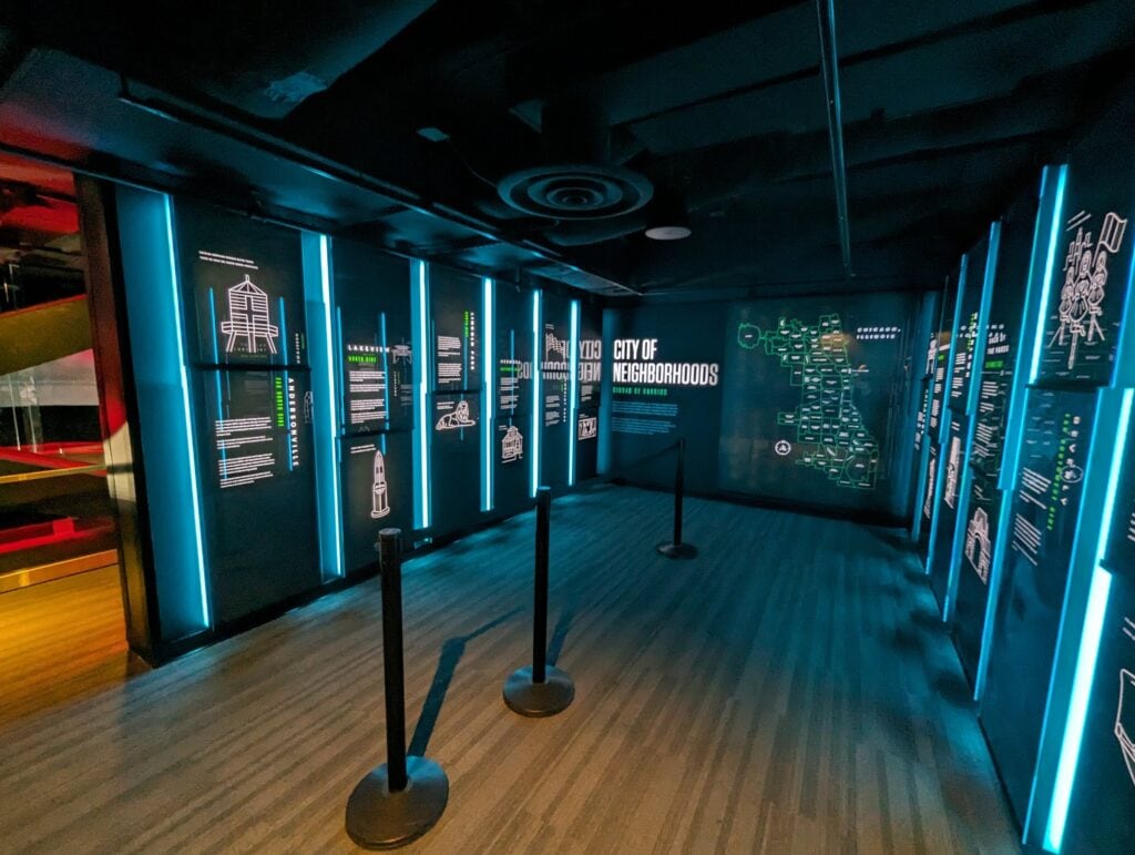 360 CHICAGO welcome experience, 875 North Michigan Avenue, Chicago — exhibit hall with LED columns and queue stanchions