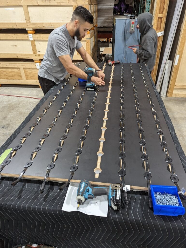 360 CHICAGO welcome experience, 875 North Michigan Avenue, Chicago — shop crew assembling LED-lit panels
