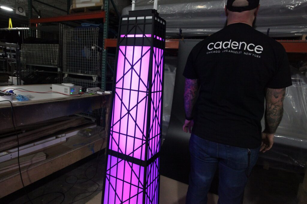 360 CHICAGO welcome experience, 875 North Michigan Avenue, Chicago — lit model tower and the Cadence crew