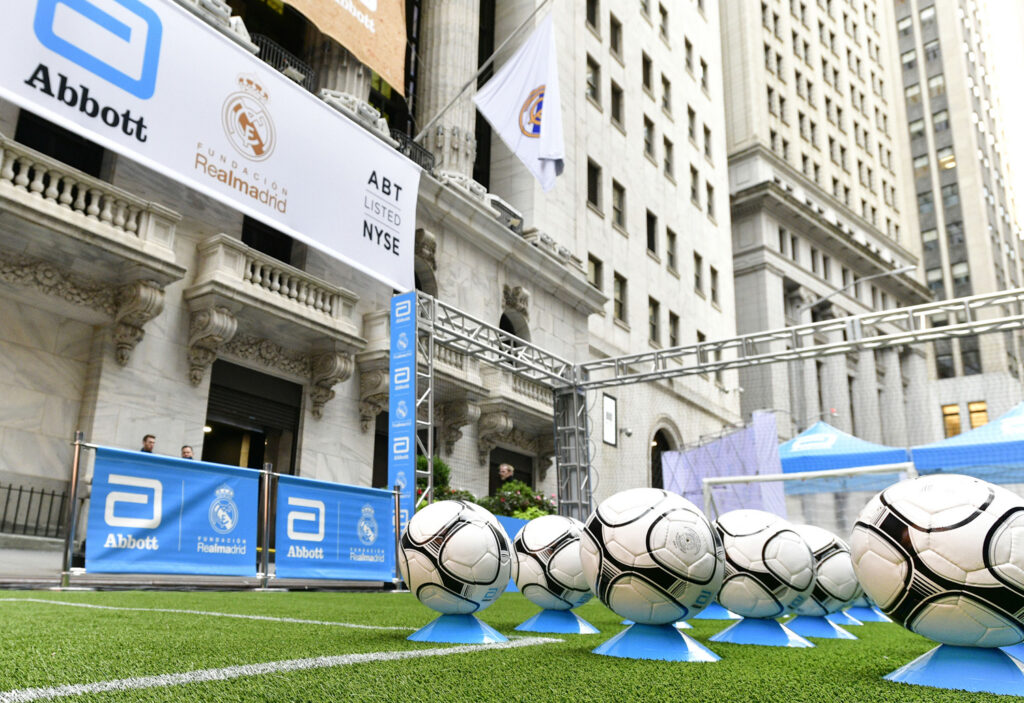 Real turf soccer pitch with Abbott and Real Madrid branding outside the New York Stock Exchange on Wall Street