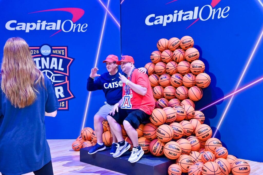 Fans posing in the basketball photo op at Capital One Fan Jam
