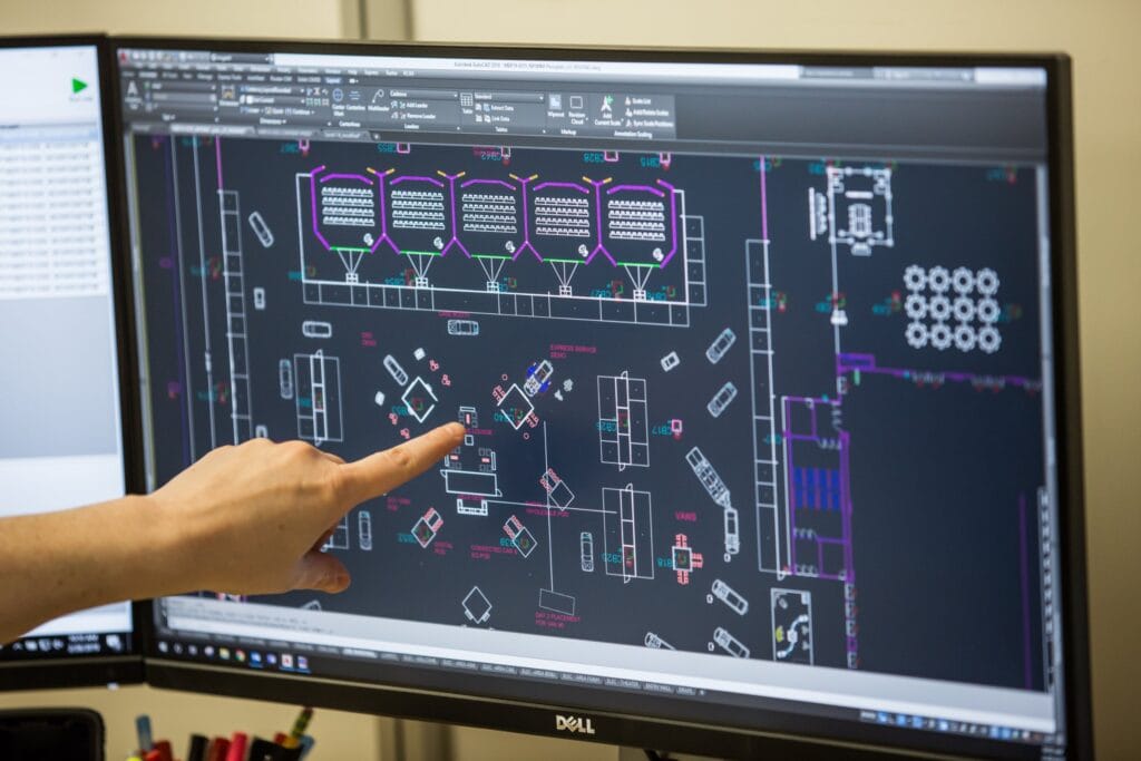 Reviewing an expo floor plan on screen at the Cadence office