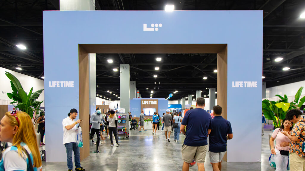 Life Time branded entrance arch and expo hall at the Life Time half marathon expo, produced by Cadence