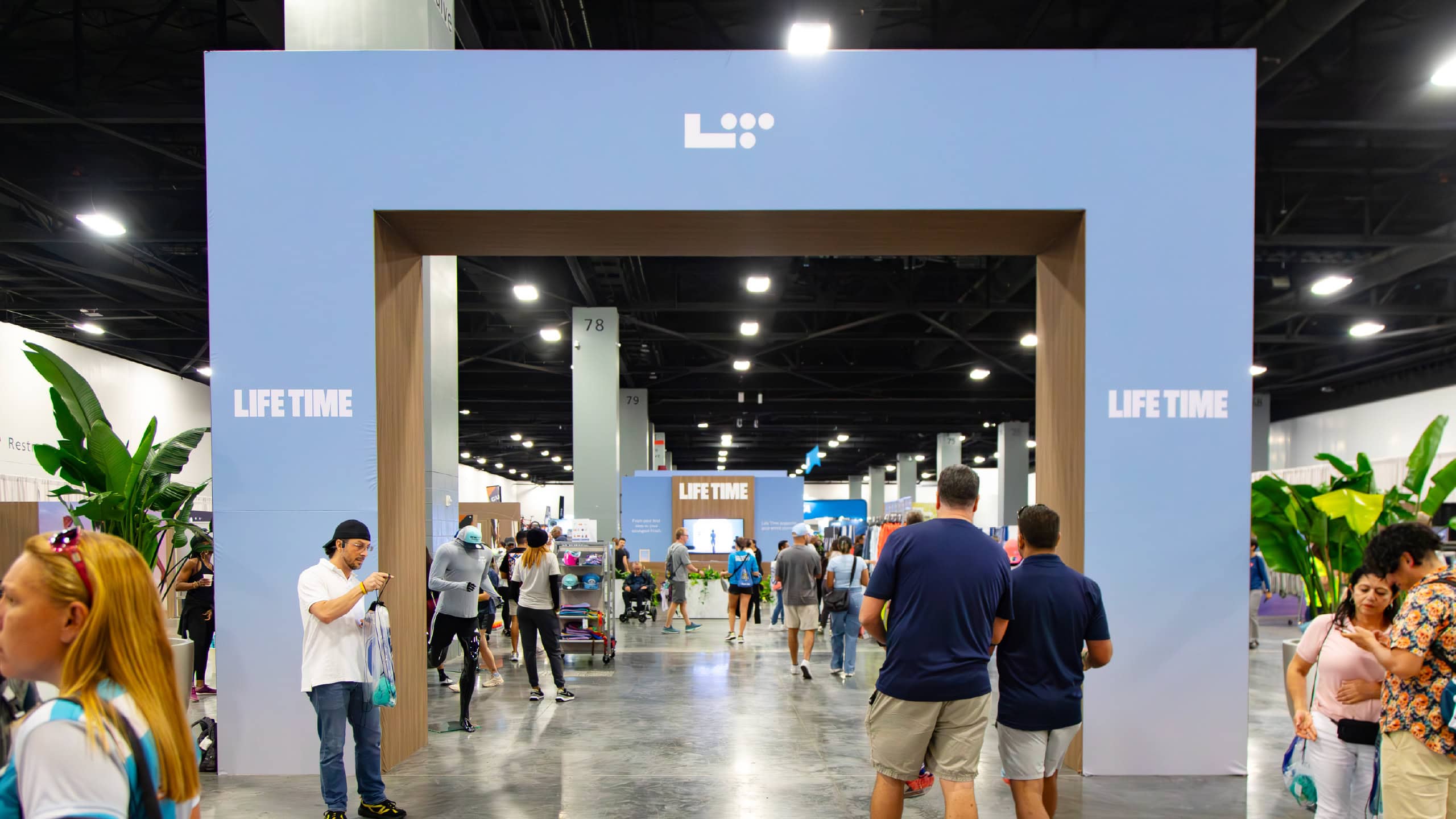 Life Time branded entrance arch and expo hall at the Life Time half marathon expo, produced by Cadence