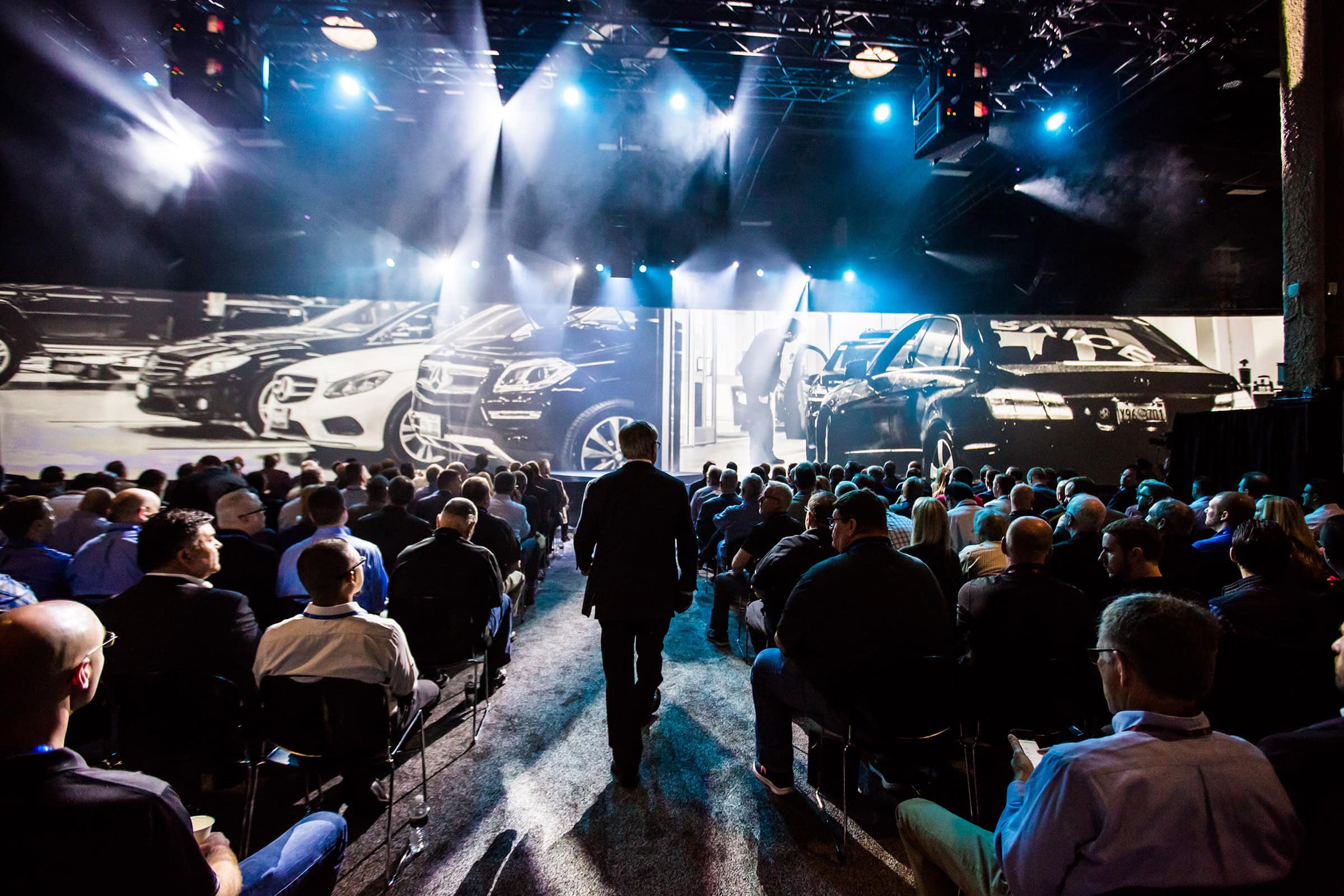 General session audience facing a large LED stage at the Mercedes-Benz National Parts and Service Managers Meeting