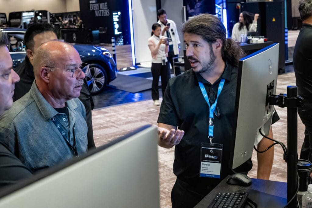 Mercedes-Benz NPSMM at Virgin Hotels Las Vegas — dealer reviewing data at a booth workstation
