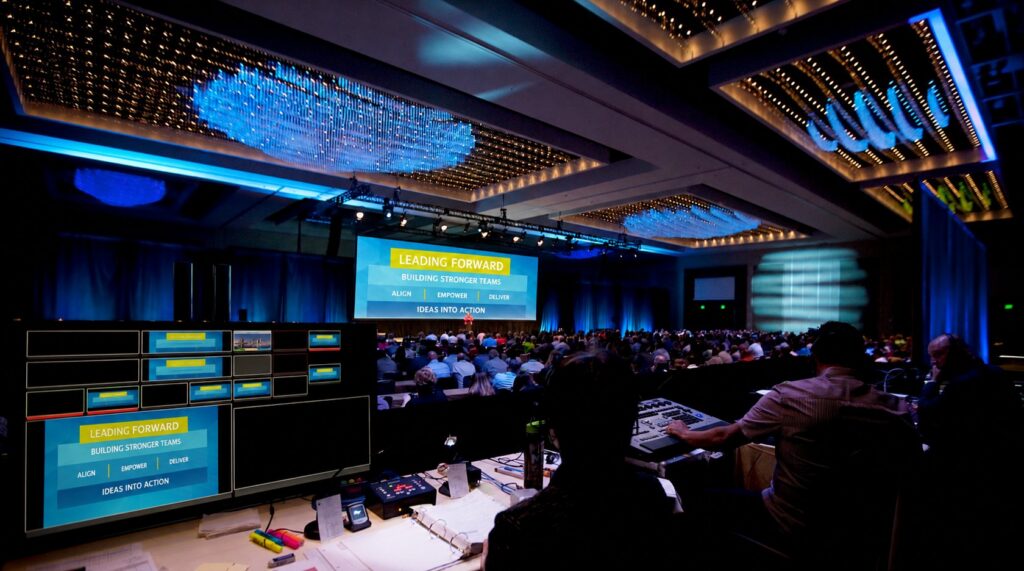 General session audience and stage screens