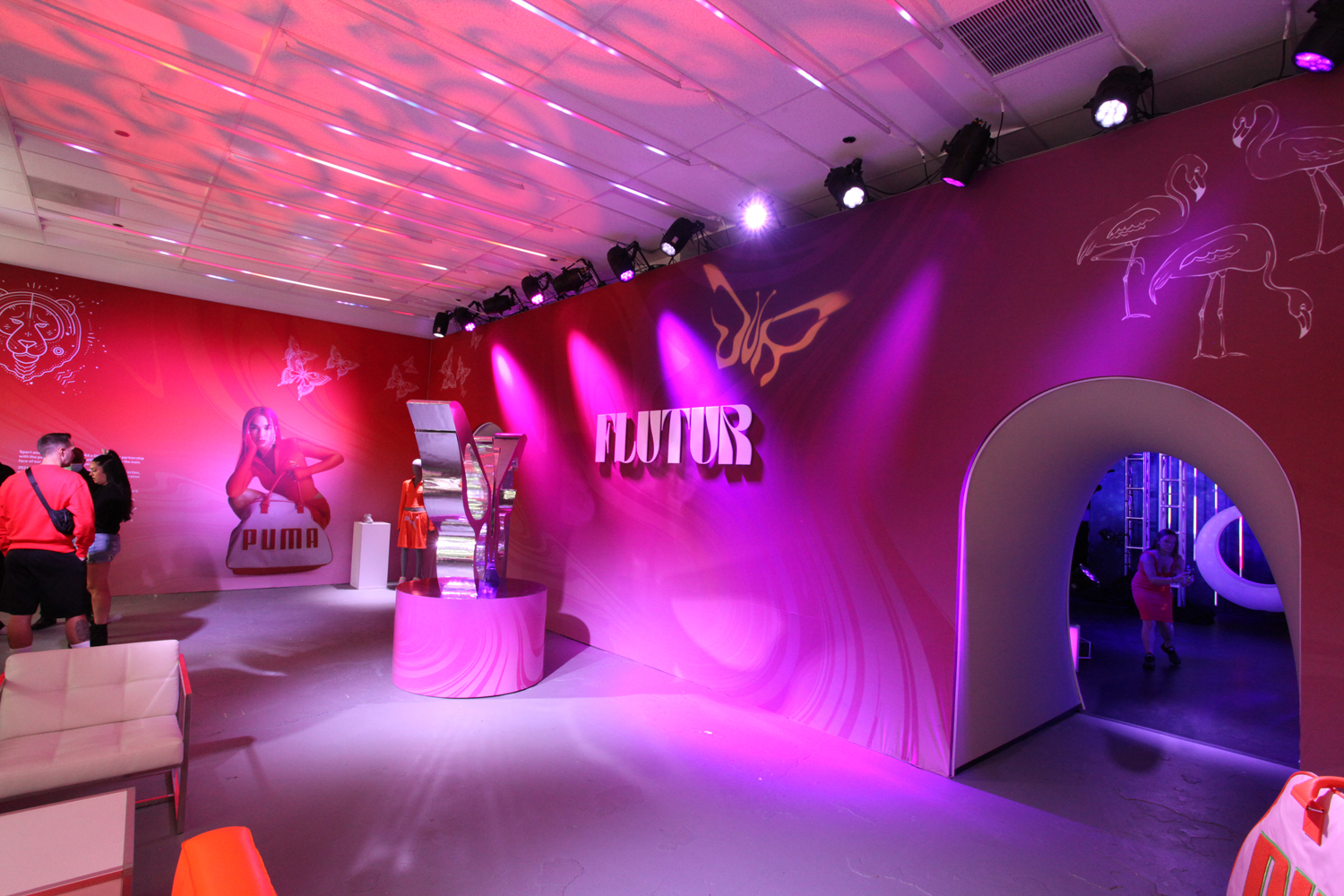 PUMA Flutur pop-up interior in pink lighting with sculptural Flutur signage on Michigan Avenue