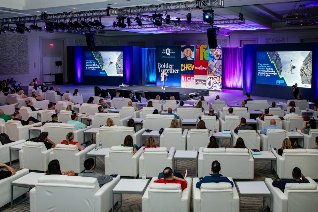 Quaker general session audience and stage screens