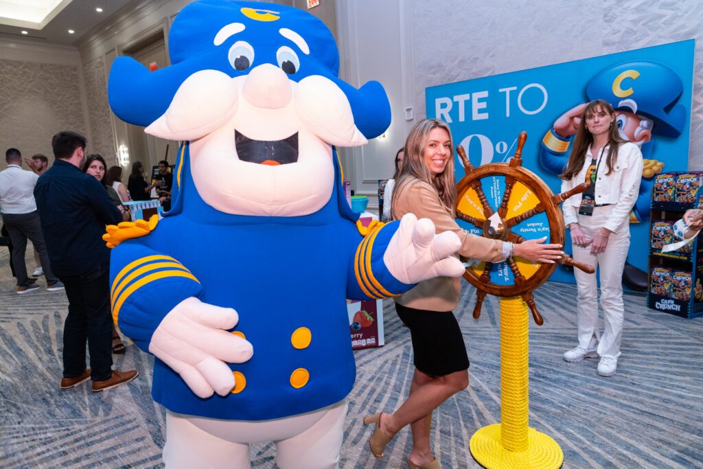Cap'n Crunch character with attendees in the brand lounge
